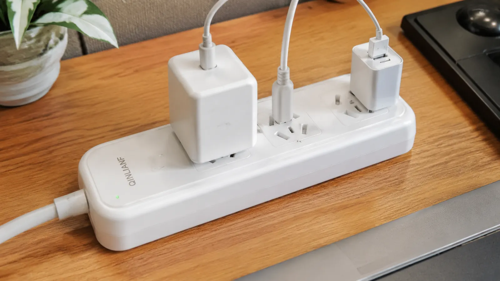 Close-up of a power strip's 3-sided angled outlets holding several differently sized plugs at once without blocking each other
